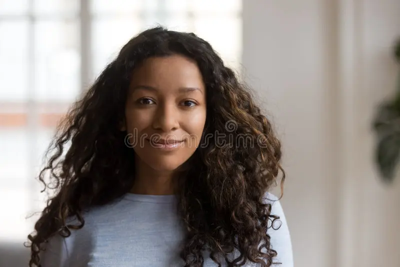 attractive young mixed race black woman posing home portrait happy african girl smiling looking camera adult indoors dark 136500321